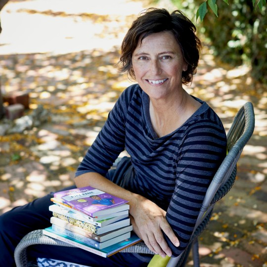 deb fitzpatrick sitting outside with books